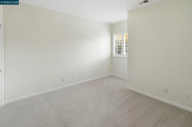 a living room with furniture and potted plants