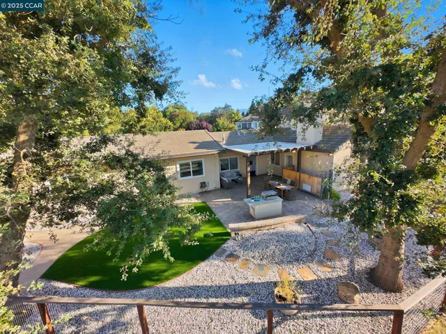 a swimming pool with outdoor seating and yard
