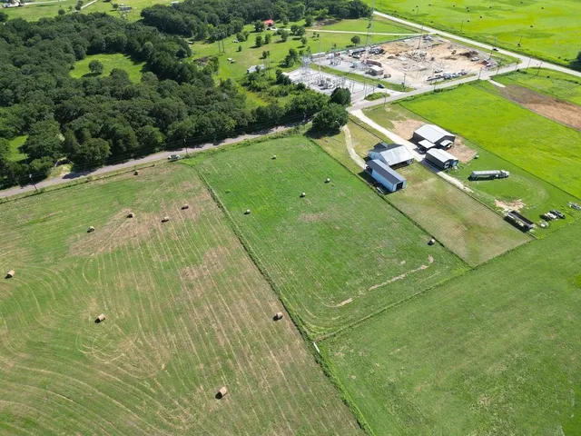 a green field with lots of tress in it