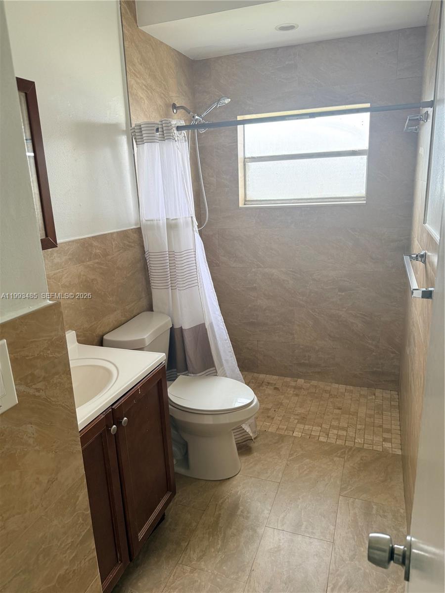 26468 Southwest 123rd Place Homestead, FL 33032 - Photo 18 of 33 a bathroom with a sink a toilet and shower