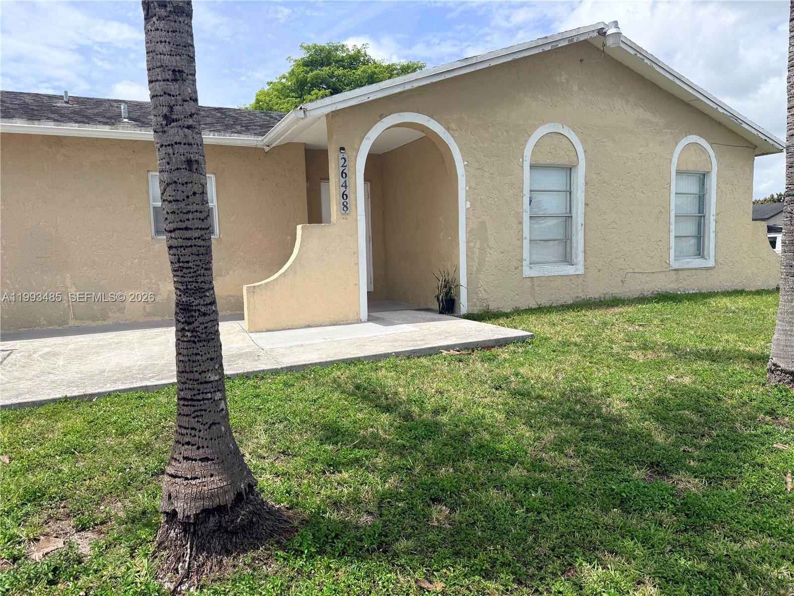 26468 Southwest 123rd Place Homestead, FL 33032 - Photo 2 of 33 a front view of a house with garden