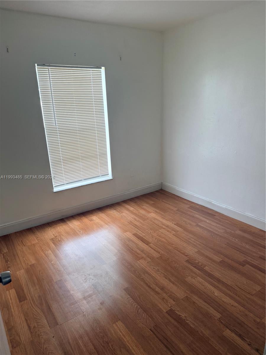 26468 Southwest 123rd Place Homestead, FL 33032 - Photo 21 of 33 an empty room with wooden floor and a window