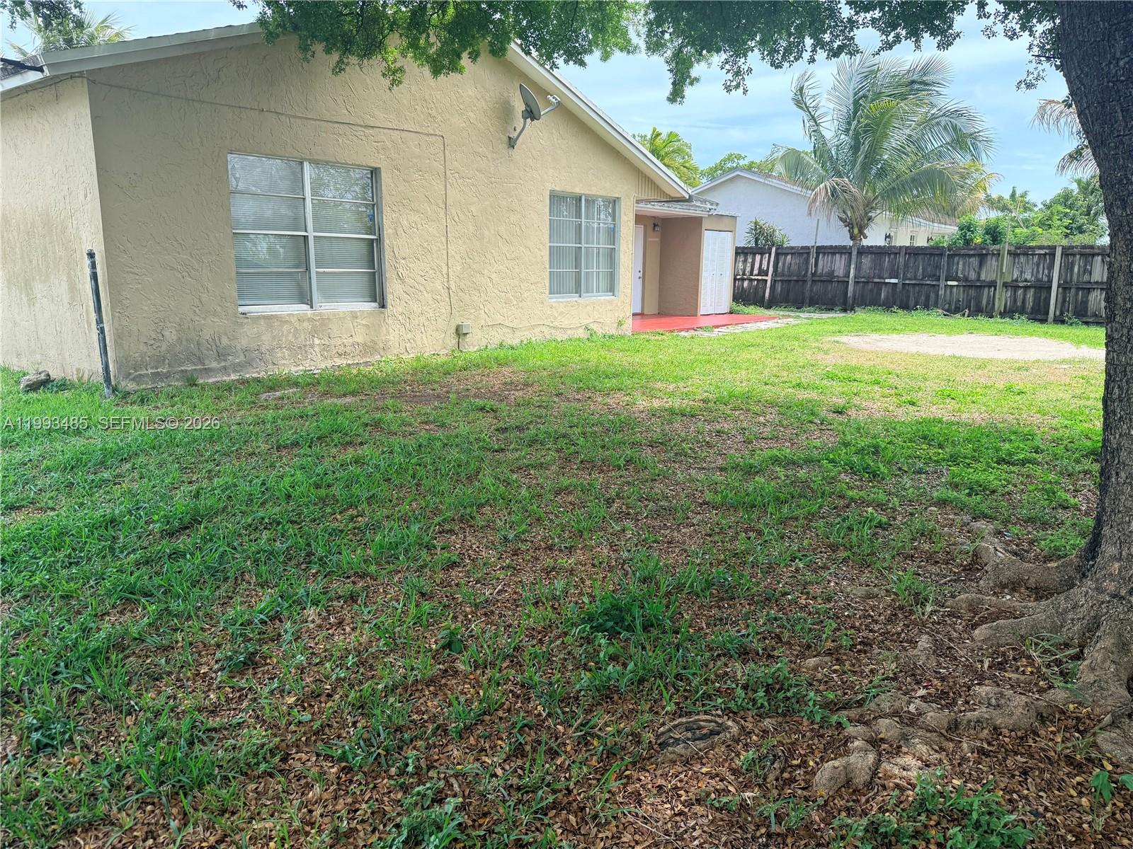 26468 Southwest 123rd Place Homestead, FL 33032 - Photo 32 of 33 a view of a house with a yard and trees