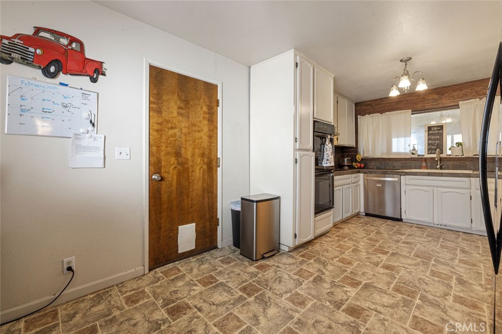 9068 Montero Road Valley Springs, CA 95252 - Photo 11 of 50 a kitchen with stainless steel appliances granite countertop a refrigerator and a stove top oven