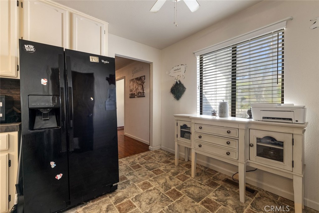 9068 Montero Road Valley Springs, CA 95252 - Photo 12 of 50 a kitchen with stainless steel appliances kitchen island granite countertop a refrigerator and a stove top oven