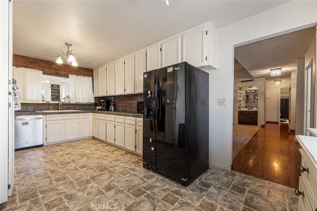 9068 Montero Road Valley Springs, CA 95252 - Photo 13 of 50 a kitchen with granite countertop a refrigerator and a sink