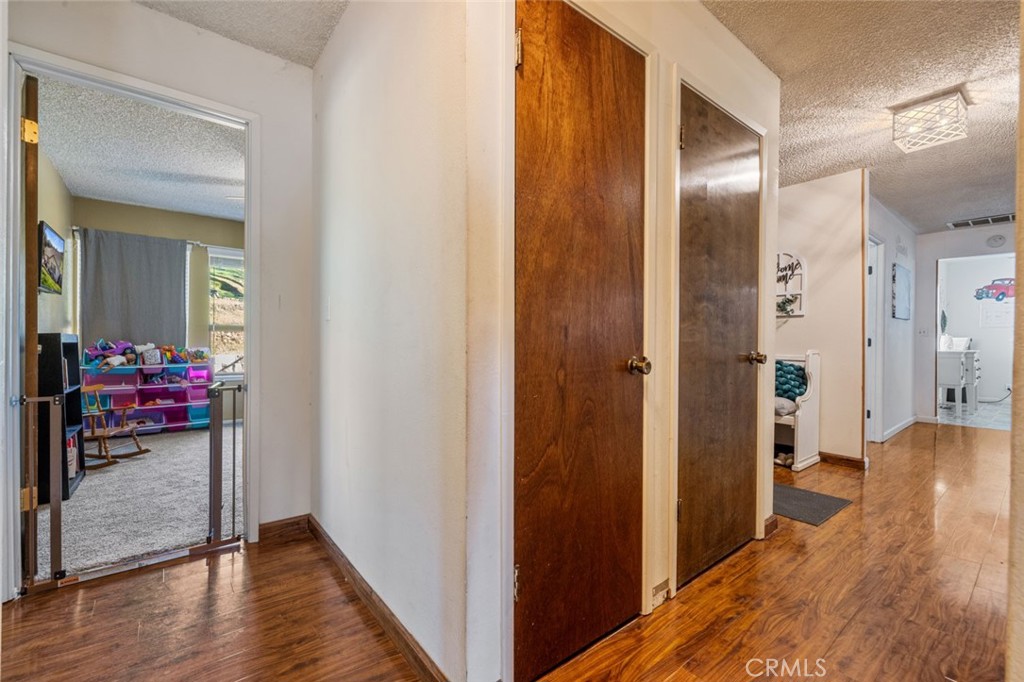 9068 Montero Road Valley Springs, CA 95252 - Photo 18 of 50 a view of a hallway with wooden floor closet and bathroom