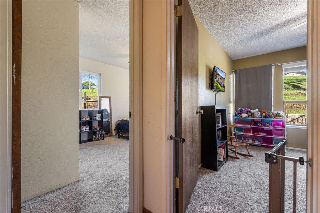 9068 Montero Road Valley Springs, CA 95252 - Photo 20 of 50 a view of a bedroom with a bed and a window