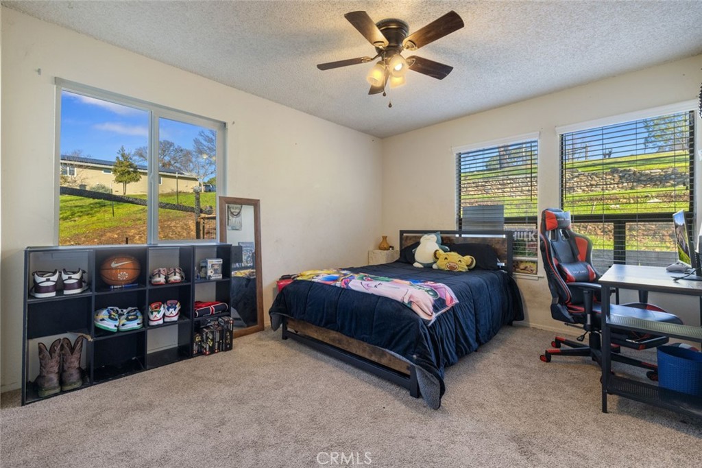 9068 Montero Road Valley Springs, CA 95252 - Photo 22 of 50 a bedroom with a bed gym equipment and a window
