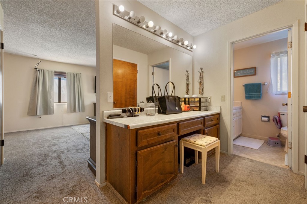 9068 Montero Road Valley Springs, CA 95252 - Photo 26 of 50 a bathroom with a sink a toilet and a mirror