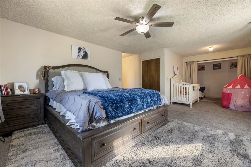 9068 Montero Road Valley Springs, CA 95252 - Photo 29 of 50 a bedroom with a bed and a chandelier