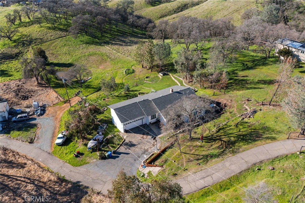 9068 Montero Road Valley Springs, CA 95252 - Photo 49 of 50 a view of a garden with lawn chairs under an umbrella