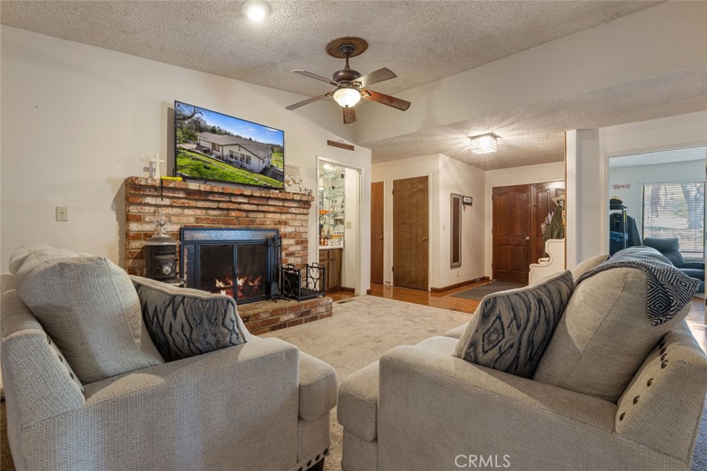 9068 Montero Road Valley Springs, CA 95252 - Photo 7 of 50 a living room with furniture a fireplace and a flat screen tv