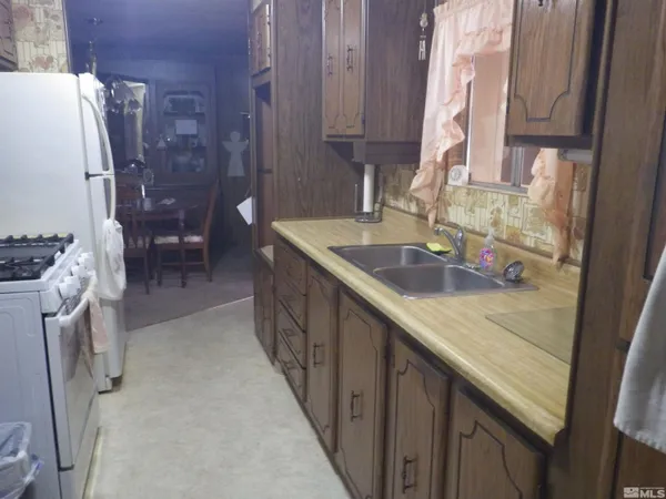 a kitchen with a sink a stove and a refrigerator
