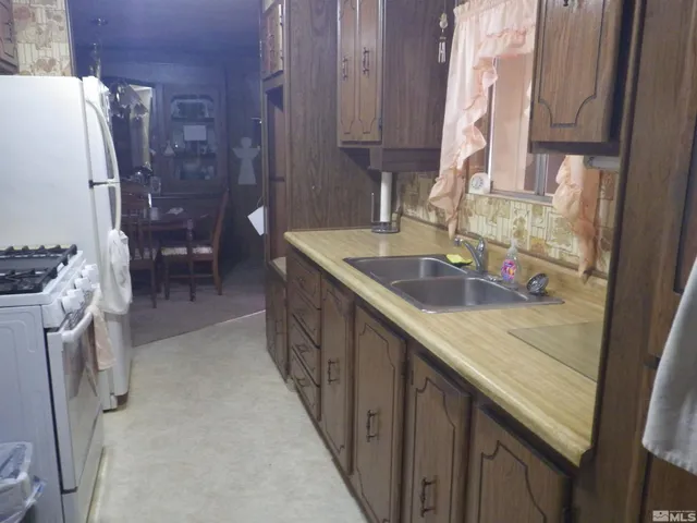 a kitchen with a sink a stove and a refrigerator