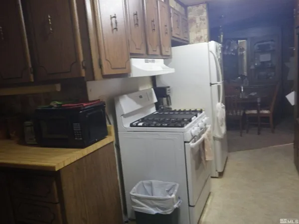 a kitchen with a stove and a refrigerator
