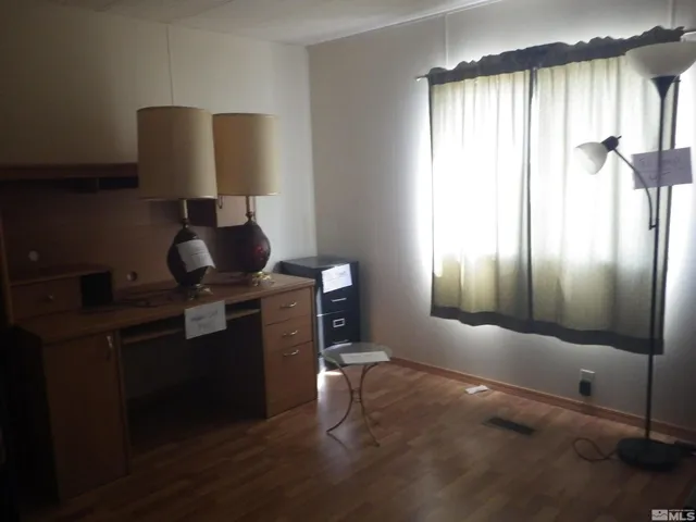 a living room with furniture and floor to ceiling windows