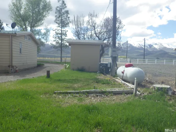 a backyard of a house with table and chairs