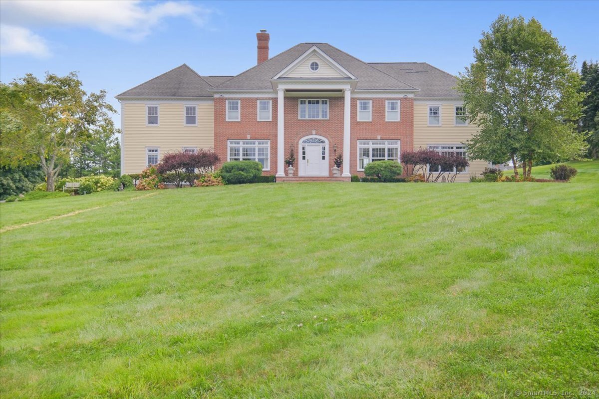43 Chestnut Hill Road Ridgefield, CT 06877 - Photo 1 of 1 a front of a house with a yard