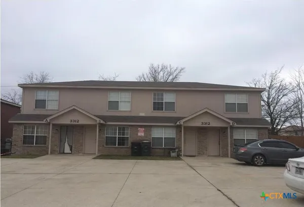 a front view of a house with parking space