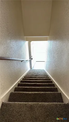 a view of a livingroom with a ceiling fan and window