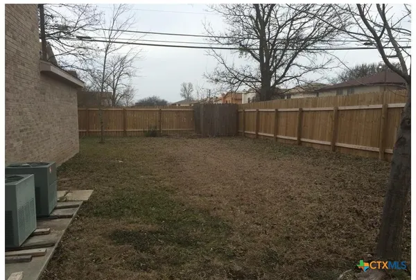 a view of a backyard of the house