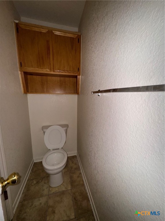 3312 Cantabrian Drive, Unit C Killeen, TX 76542 - Photo 6 of 21 a bathroom with a toilet and a shower curtain