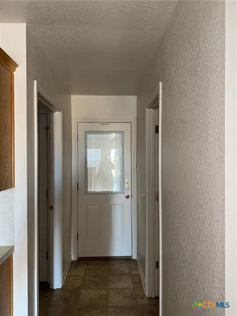 a kitchen with a refrigerator and a sink