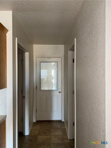 a kitchen with a refrigerator and a sink