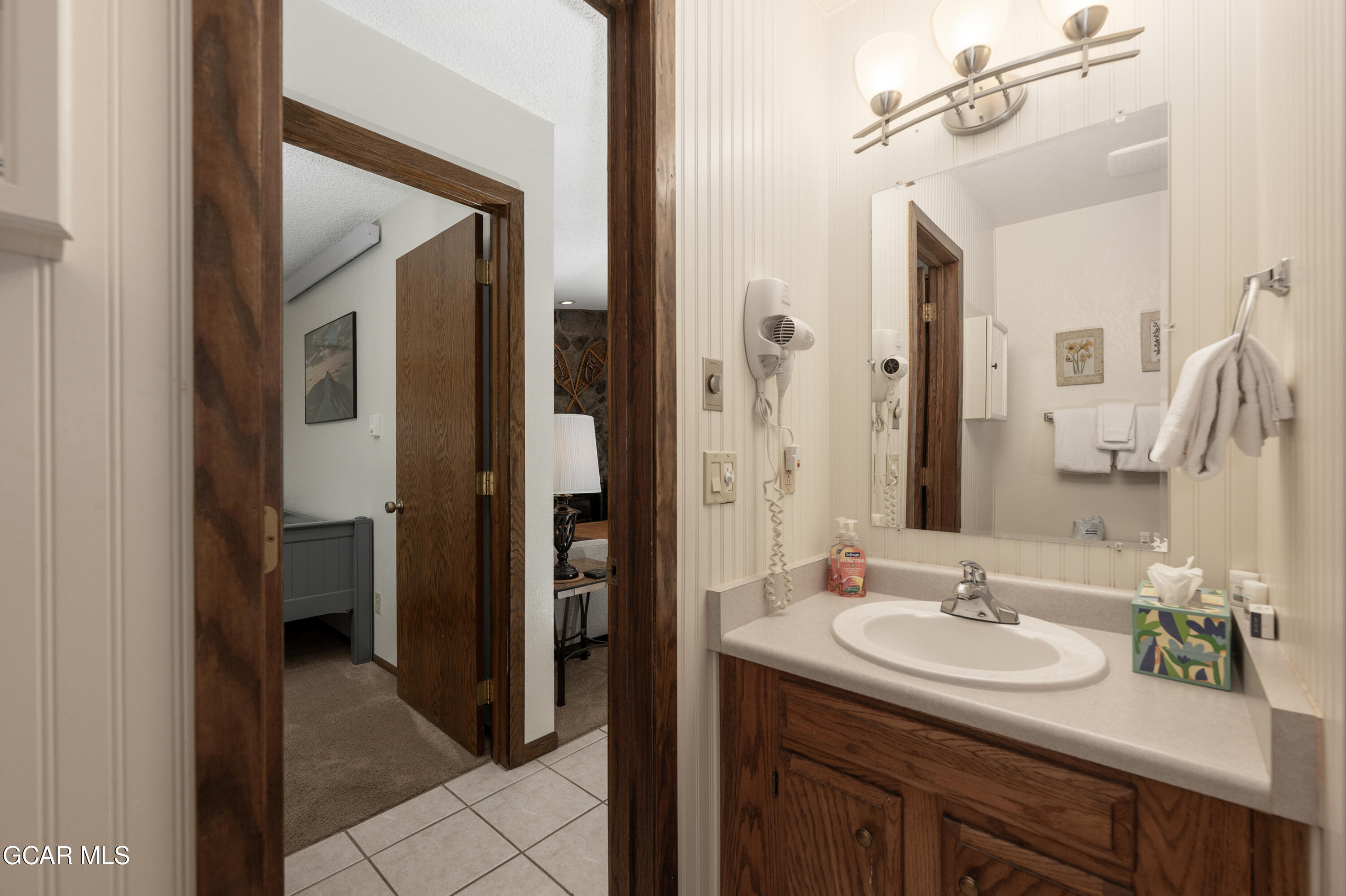 490 Kings Crossing Road, Unit 331 Winter Park, CO 80482 - Photo 18 of 38 a en suite bathroom with a sink and a mirror