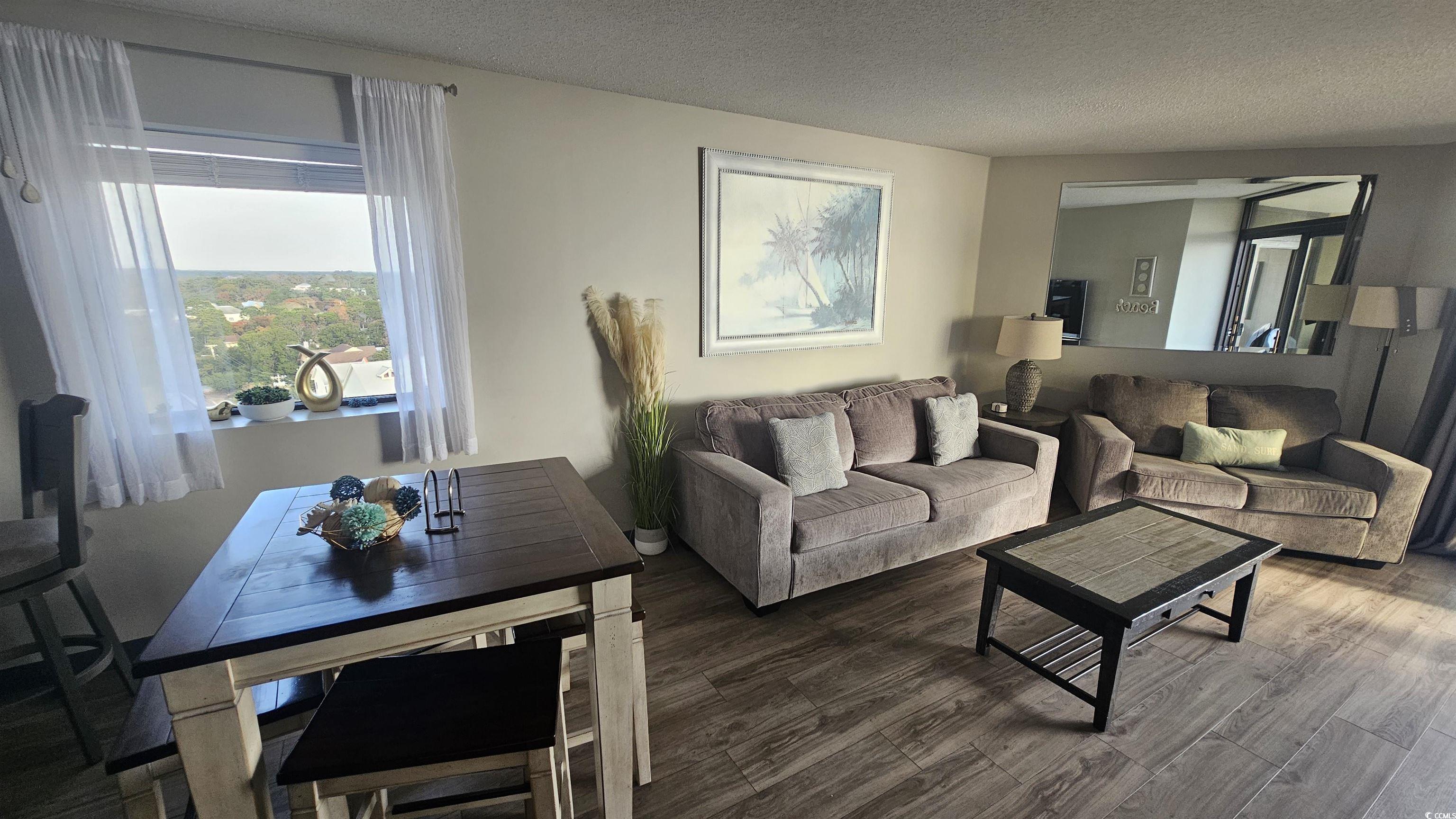 201 74th Avenue North, Unit 1201 Myrtle Beach, SC 29572 - Photo 14 of 40 Living room featuring a textured ceiling and wood finished floors