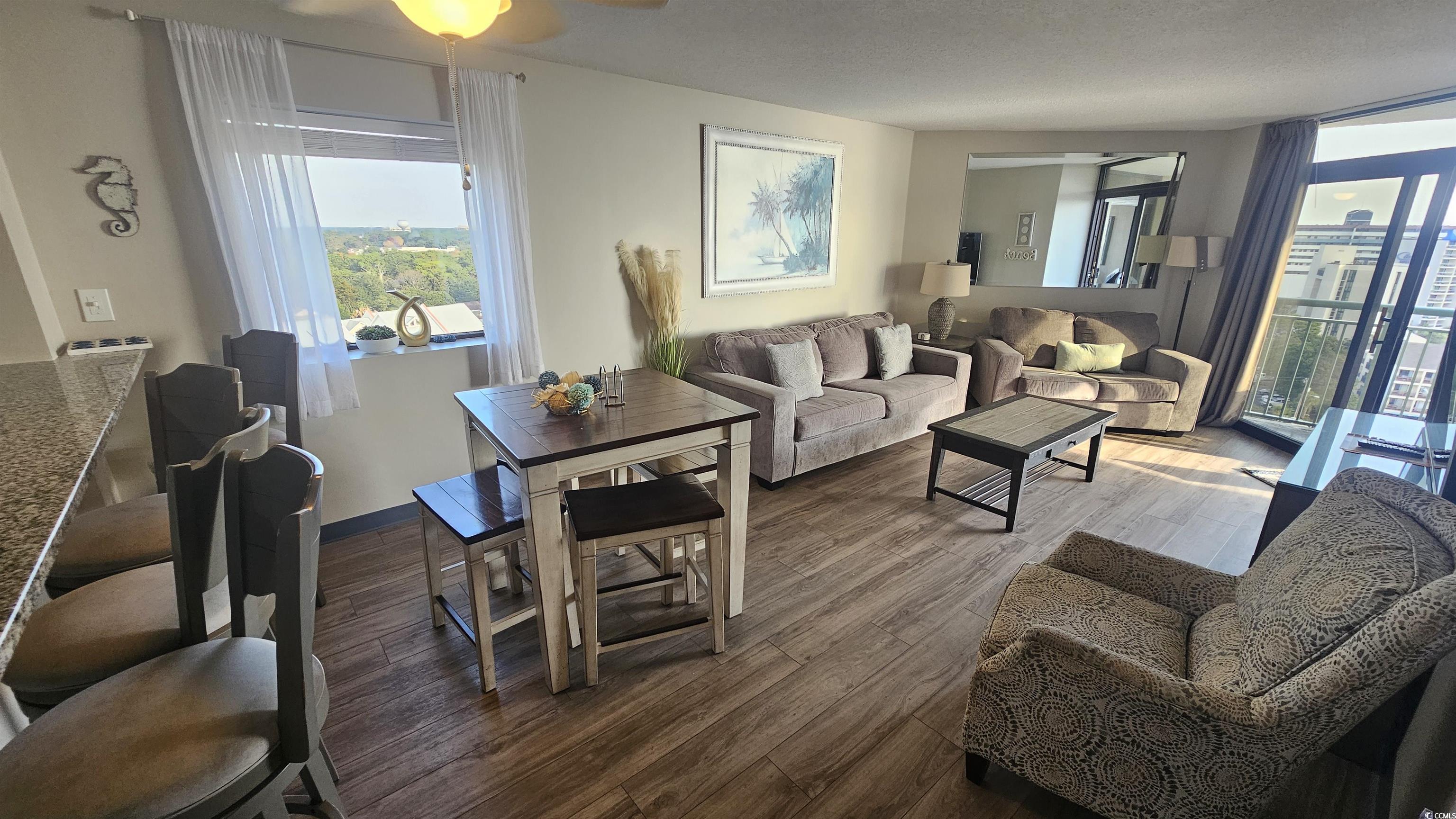 201 74th Avenue North, Unit 1201 Myrtle Beach, SC 29572 - Photo 15 of 40 Living area featuring dark wood-style floors and a ceiling fan