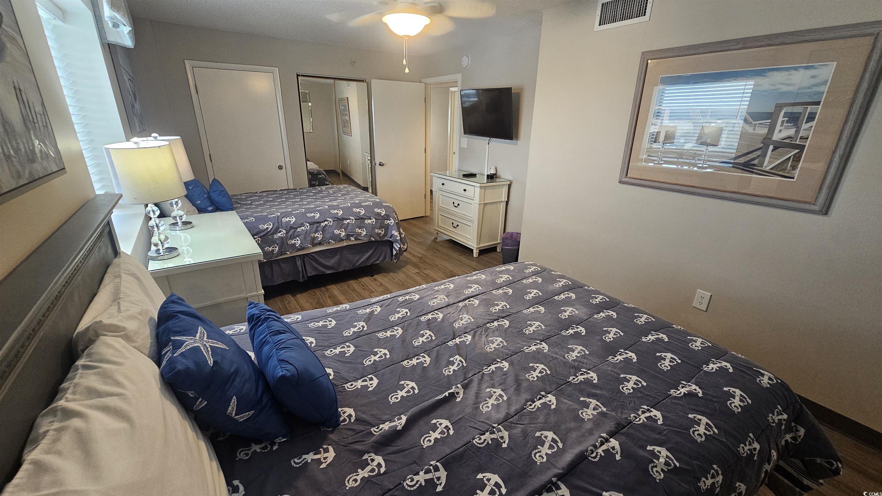 201 74th Avenue North, Unit 1201 Myrtle Beach, SC 29572 - Photo 21 of 40 Bedroom featuring dark wood-style flooring and ceiling fan