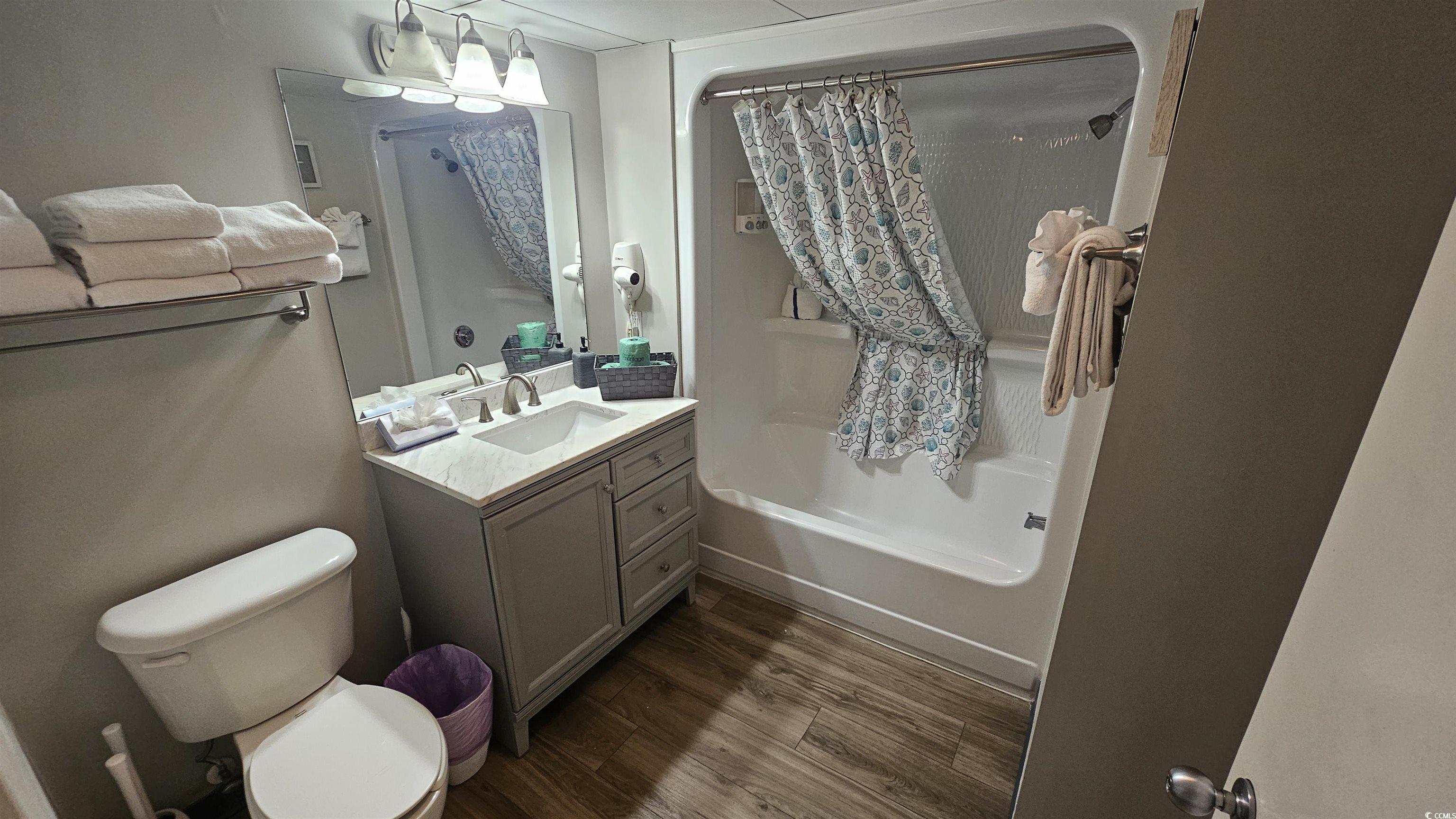 201 74th Avenue North, Unit 1201 Myrtle Beach, SC 29572 - Photo 25 of 40 Bathroom featuring vanity, shower / bath combo with shower curtain, and dark wood-style flooring