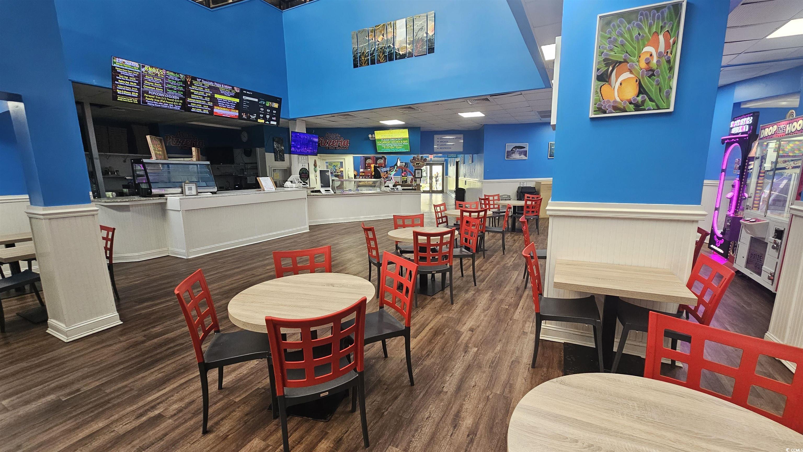 201 74th Avenue North, Unit 1201 Myrtle Beach, SC 29572 - Photo 28 of 40 Dining room featuring a drop ceiling, a wainscoted wall, and dark wood-style flooring