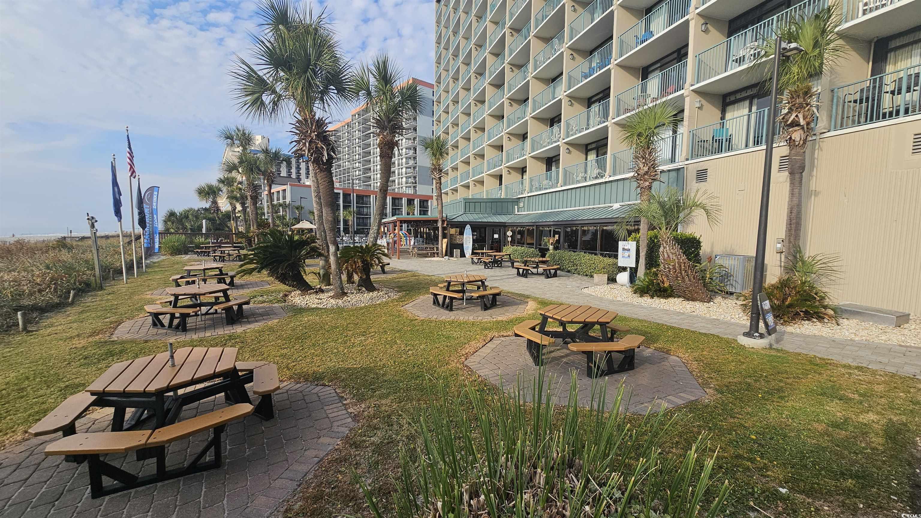 201 74th Avenue North, Unit 1201 Myrtle Beach, SC 29572 - Photo 30 of 40 Surrounding community with a patio area and a yard