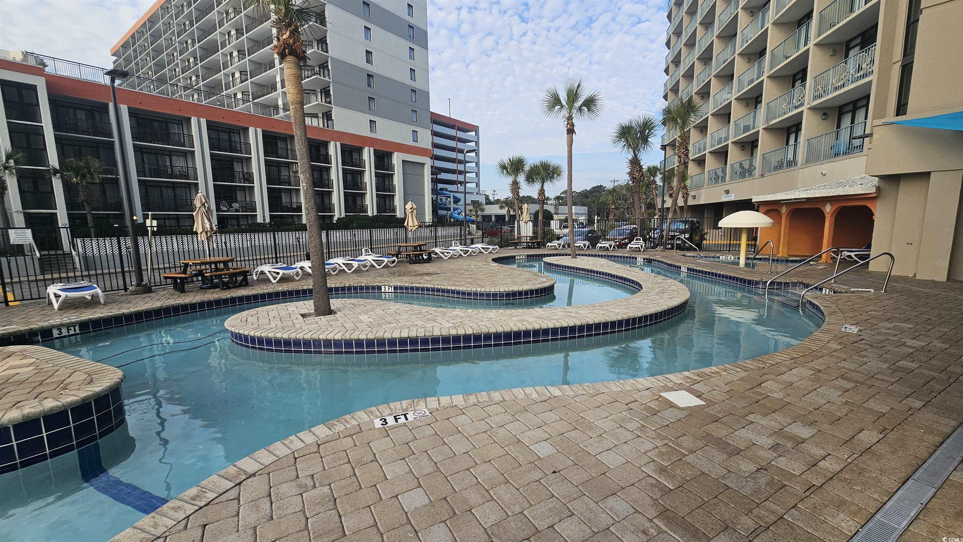 201 74th Avenue North, Unit 1201 Myrtle Beach, SC 29572 - Photo 33 of 40 Community pool featuring a patio