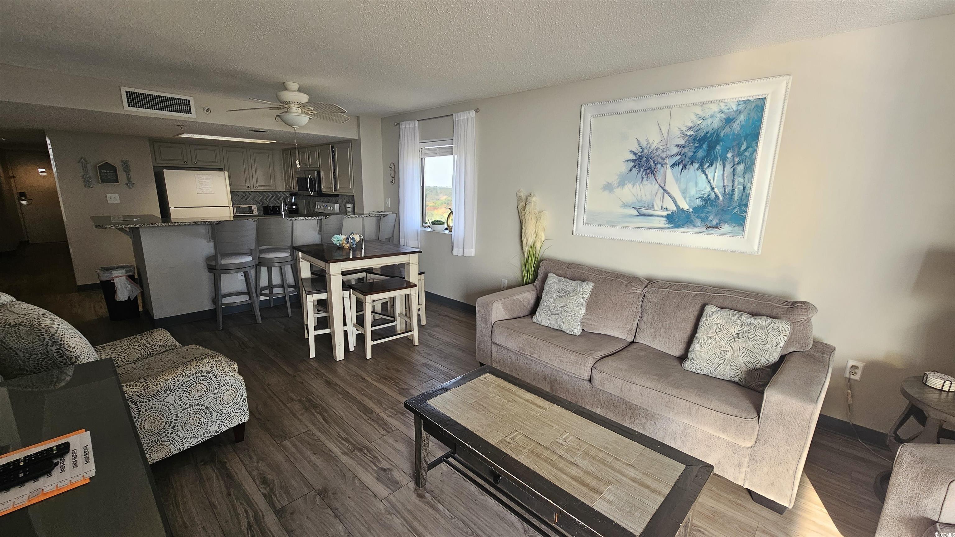 201 74th Avenue North, Unit 1201 Myrtle Beach, SC 29572 - Photo 7 of 40 Living room with a textured ceiling, ceiling fan, and dark wood-style floors