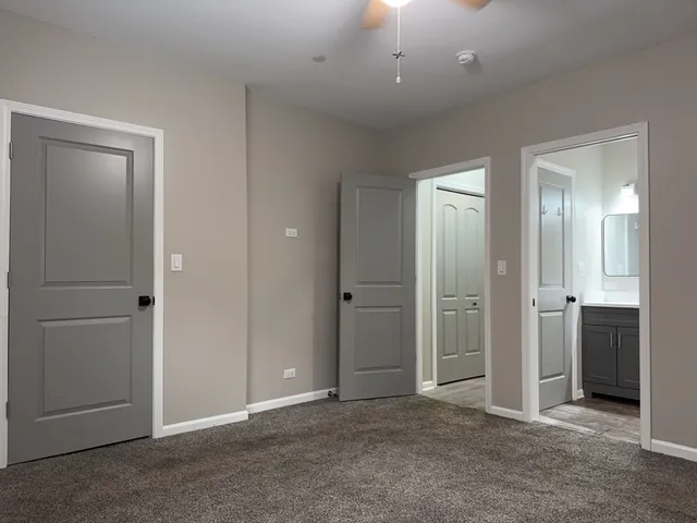 an empty room with closet and a bathroom
