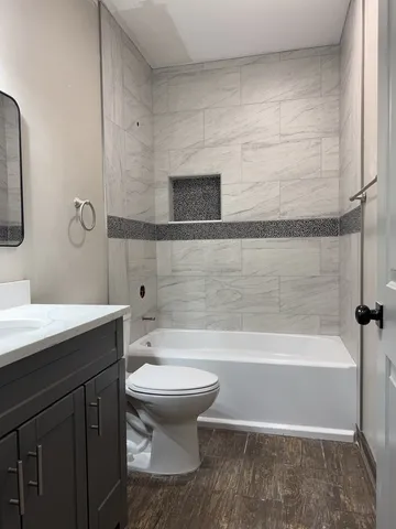 a bathroom with a sink a toilet and bathtub