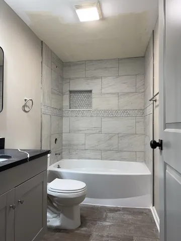 a bathroom with a toilet a sink and bathtub