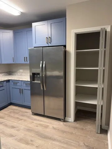 a kitchen with a refrigerator and cabinets