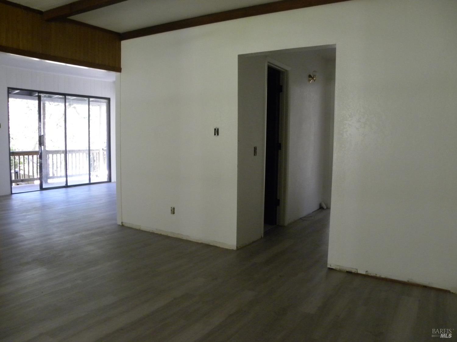8260 Trenton Road Forestville, CA 95436 - Photo 11 of 24 a view of an empty room with wooden floor and a window
