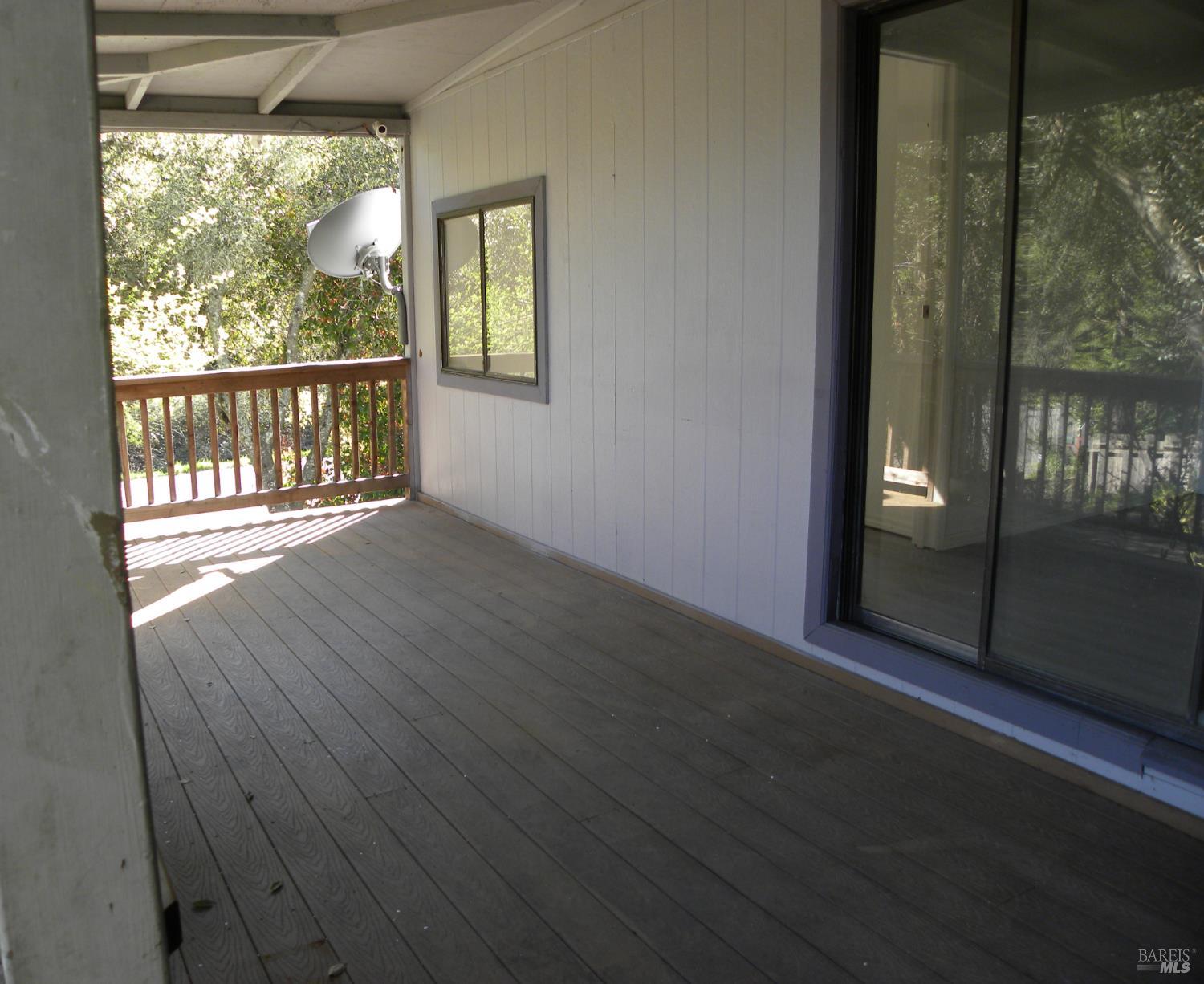 8260 Trenton Road Forestville, CA 95436 - Photo 20 of 24 a view of an empty room with wooden floor and a window