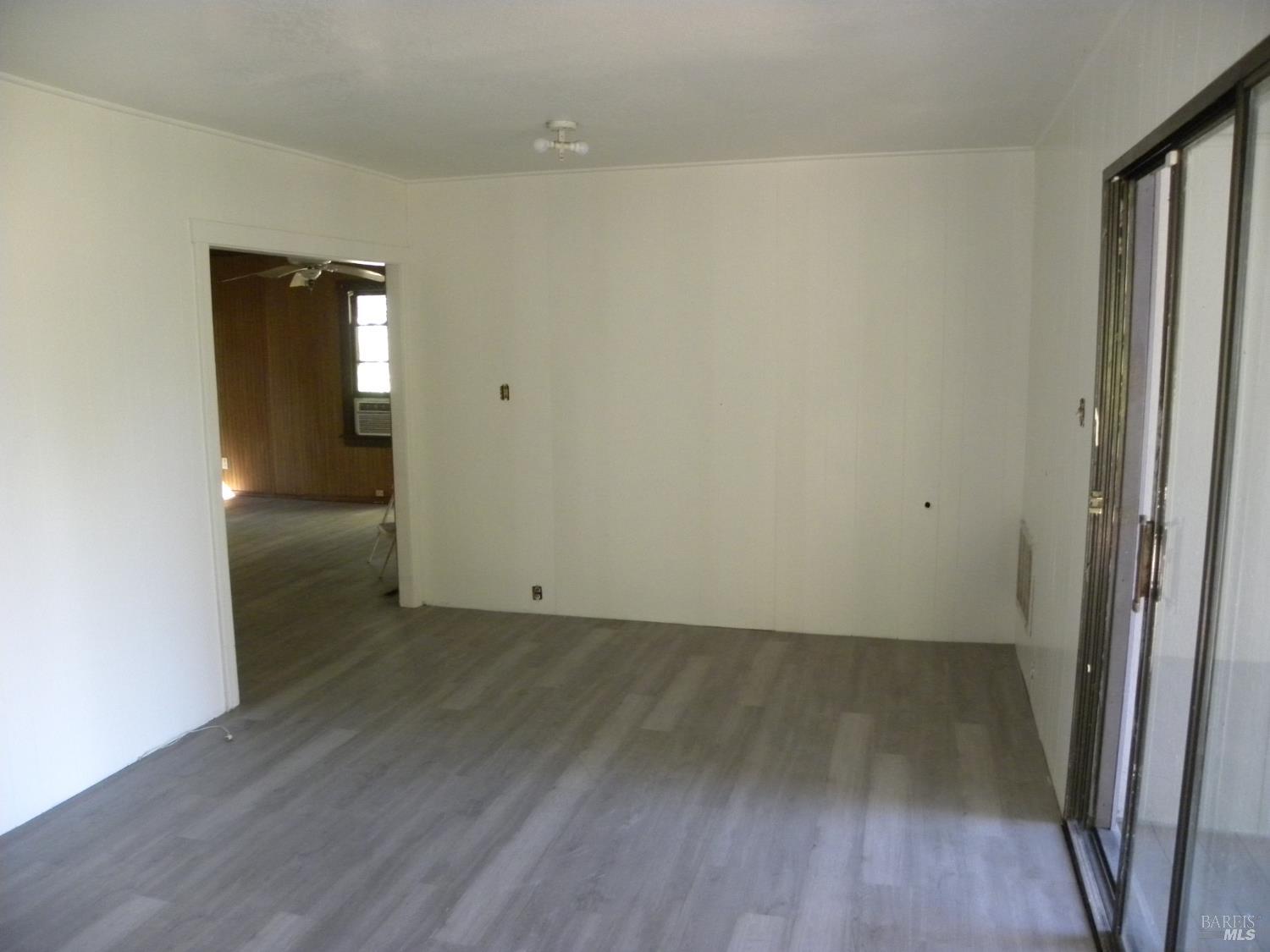 8260 Trenton Road Forestville, CA 95436 - Photo 21 of 24 an empty room with wooden floor and windows