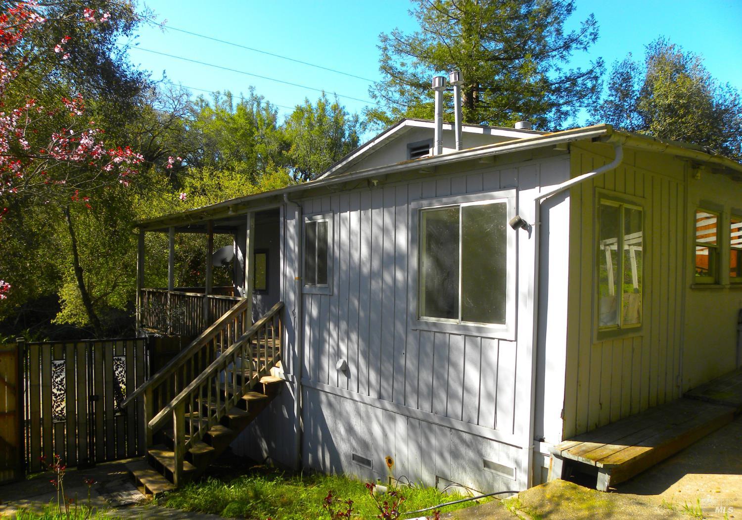 8260 Trenton Road Forestville, CA 95436 - Photo 6 of 24 a side view of a house with a yard