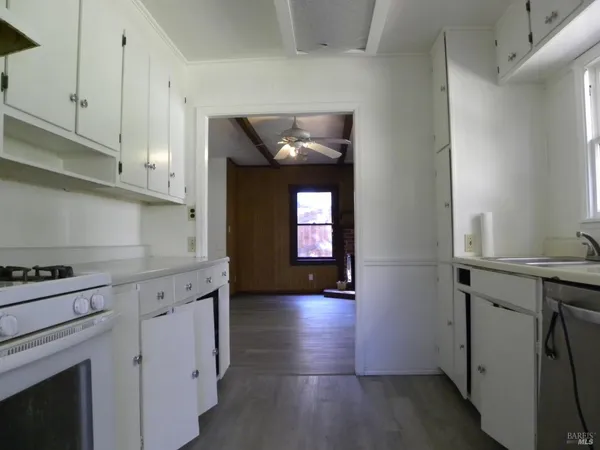 a view of a kitchen with a sink and a ceiling fan