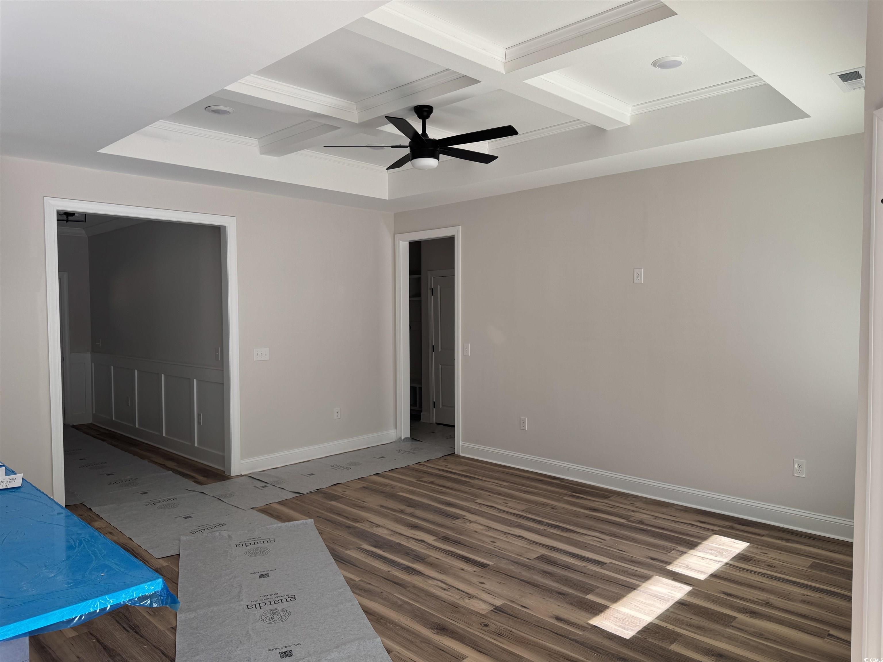 1351 White Oak Lane Galivants Ferry, SC 29544 - Photo 5 of 12 Unfurnished room with coffered ceiling, beamed ceiling, crown molding, ceiling fan, and wood finished floors