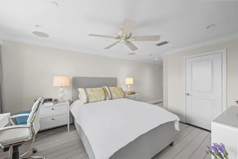 a bedroom with a bed window and a flat screen tv
