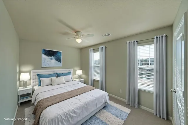 a bedroom with a large bed and a window